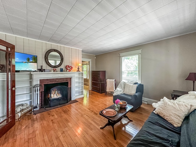 unfurnished living room with light hardwood / wood-style floors and a brick fireplace