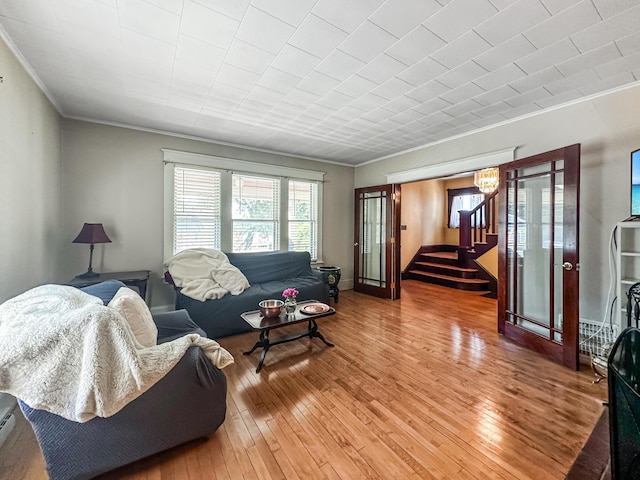 living room with hardwood / wood-style flooring and ornamental molding