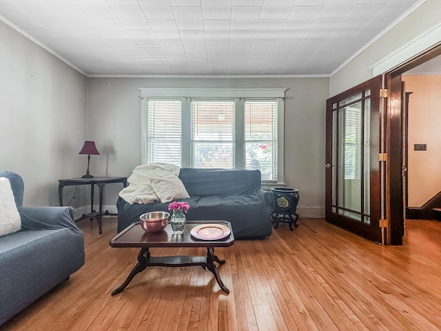 living room featuring light wood-type flooring and ornamental molding