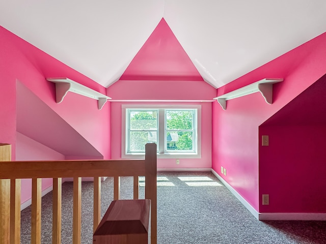 additional living space with carpet floors and vaulted ceiling