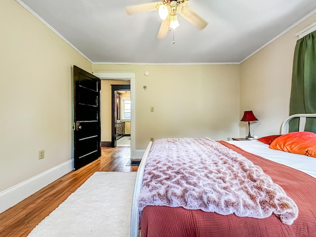 bedroom with ceiling fan, wood-type flooring, and ornamental molding