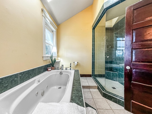 bathroom featuring tile patterned flooring, plus walk in shower, and vaulted ceiling