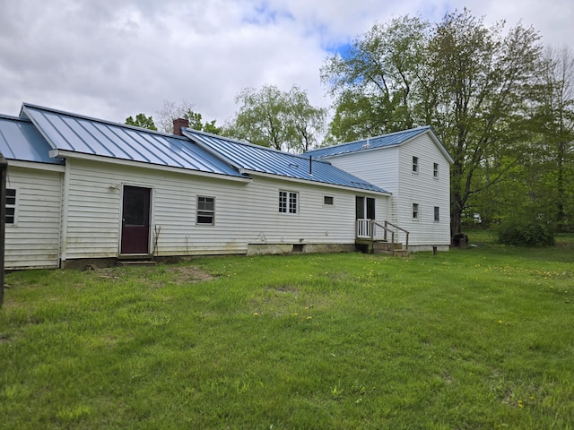 192 Fox Hill Rd, Athens, ME 04912 - back of property with a chimney, a yard, metal roof, and a standing seam roof