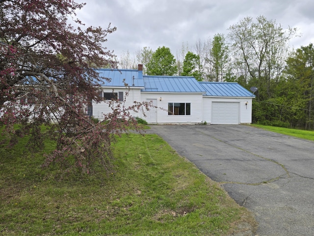 192 Fox Hill Rd, Athens, ME 04912 - view of front of home with a garage, asphalt driveway, a chimney, metal roof, and a front lawn