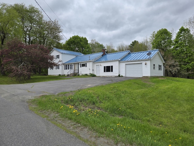 192 Fox Hill Rd, Athens, ME 04912 - view of front of house featuring driveway, a garage, a chimney, a standing seam roof, and metal roof