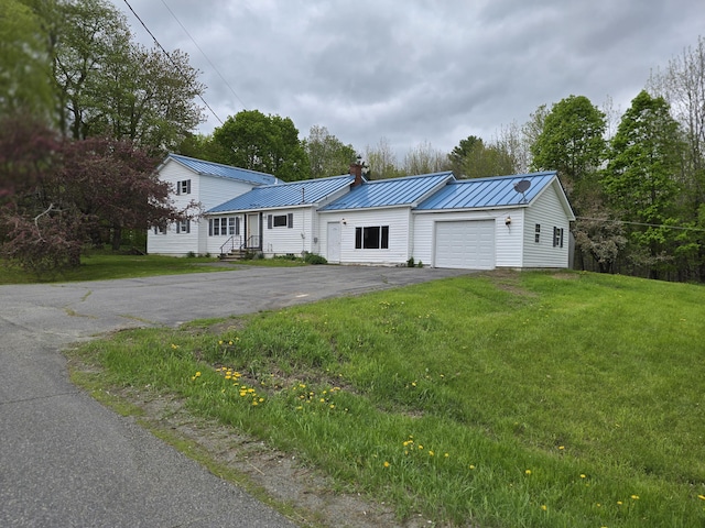 192 Fox Hill Rd, Athens, ME 04912 - view of front facade with an attached garage, asphalt driveway, a front lawn, a standing seam roof, and metal roof