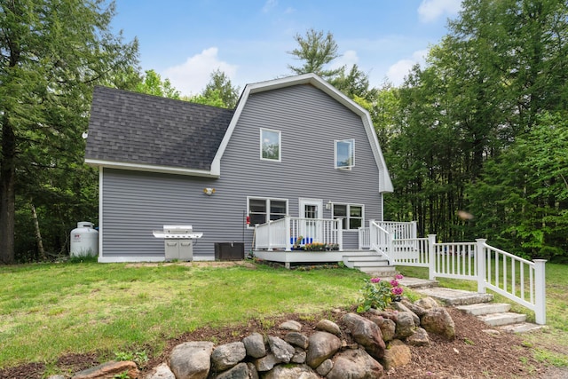 back of property featuring a yard and a deck