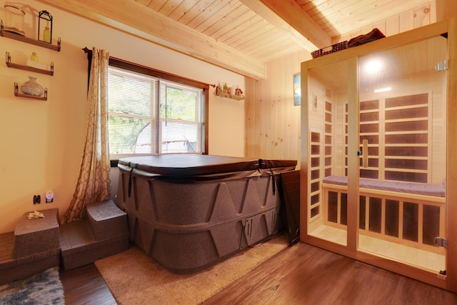 misc room with beamed ceiling, wood ceiling, wood-type flooring, and wood walls