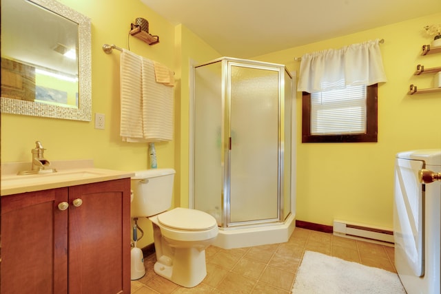 bathroom featuring a baseboard radiator, washer / dryer, vanity, walk in shower, and toilet