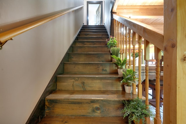 stairs featuring wooden ceiling