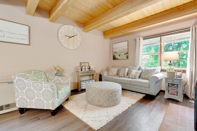 living room with hardwood / wood-style flooring, a baseboard heating unit, wooden ceiling, and beamed ceiling