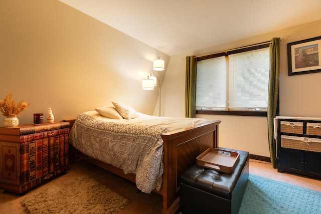 bedroom with carpet floors and vaulted ceiling