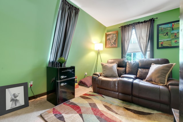 carpeted living room featuring lofted ceiling