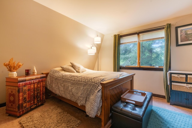 bedroom featuring carpet and lofted ceiling