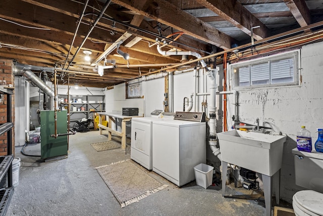 basement featuring washer and clothes dryer and sink