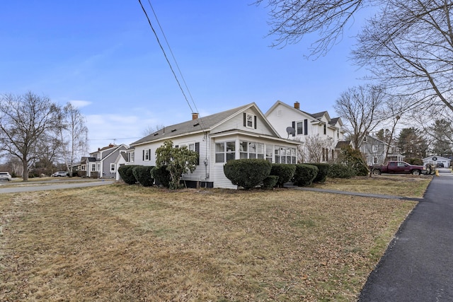 view of side of home with a yard