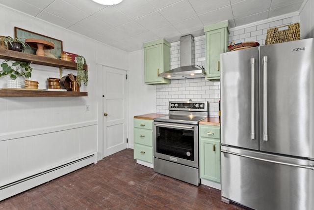 kitchen featuring wooden counters, wall chimney range hood, green cabinetry, baseboard heating, and stainless steel appliances