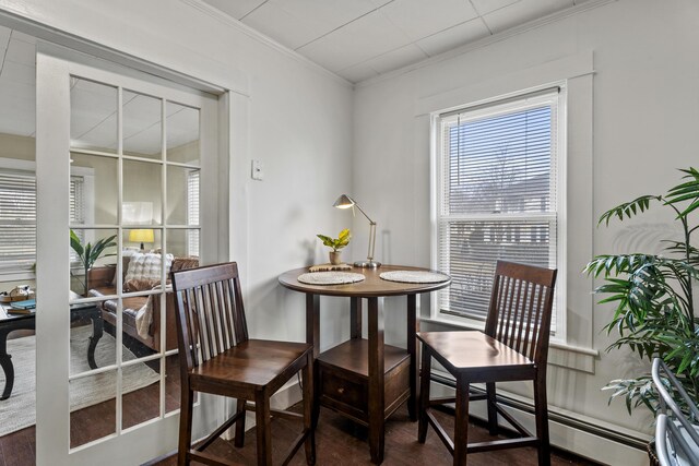 interior space with crown molding and a baseboard radiator