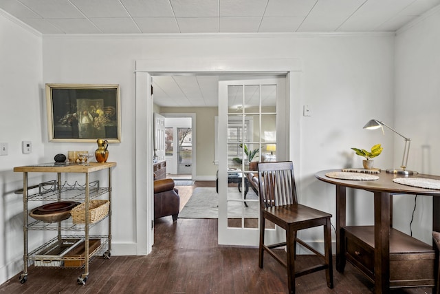 dining room featuring french doors, dark hardwood / wood-style floors, and crown molding