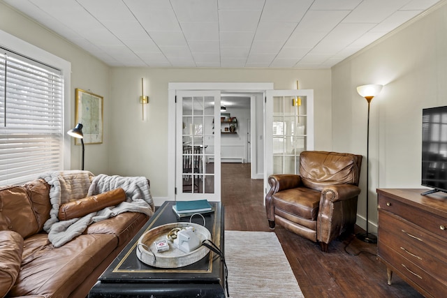 living room with baseboard heating and dark wood-type flooring