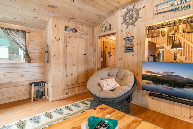 380 Cedar Lake Rd Unit T3 R9, Nwp, ME 04462 - sitting room with lofted ceiling, wood walls, wooden ceiling, wood finished floors, and a wood stove