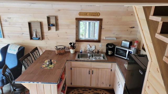 380 Cedar Lake Rd Unit T3 R9, Nwp, ME 04462 - kitchen with stainless steel microwave, a sink, wood walls, a peninsula, and a kitchen breakfast bar
