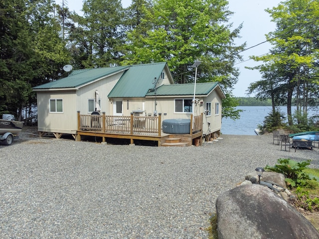 380 Cedar Lake Rd Unit T3 R9, Nwp, ME 04462 - view of front of house featuring metal roof and a deck with water view