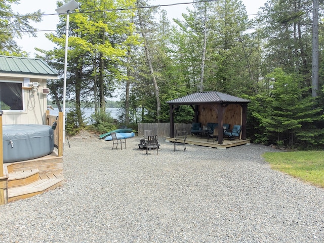 380 Cedar Lake Rd Unit T3 R9, Nwp, ME 04462 - view of patio / terrace featuring a gazebo, a hot tub, a wooden deck, and an outdoor living space with a fire pit