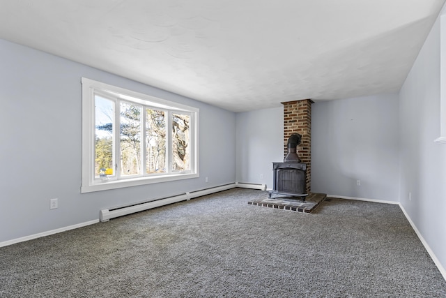 unfurnished living room with a wood stove, carpet floors, and a baseboard heating unit