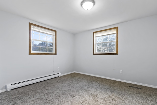 carpeted spare room with a baseboard radiator and plenty of natural light