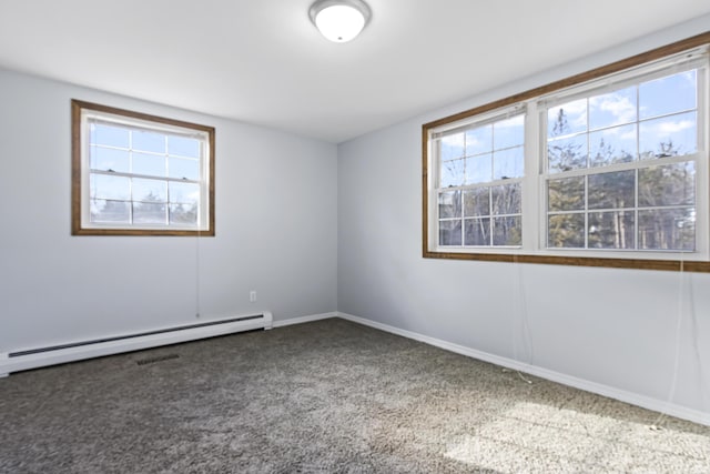 unfurnished room with carpet, a wealth of natural light, and a baseboard heating unit