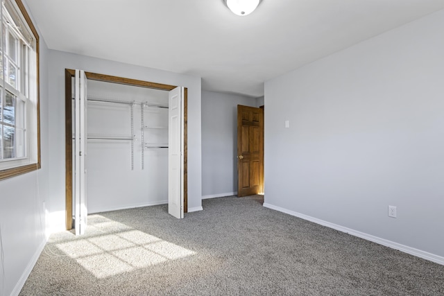 unfurnished bedroom featuring carpet flooring and a closet