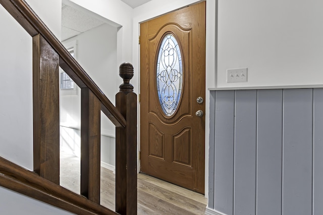 entryway with light hardwood / wood-style flooring and a textured ceiling