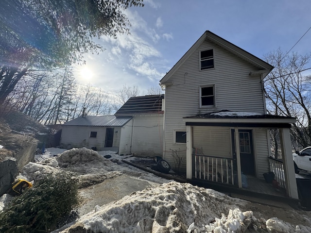 rear view of property with a porch