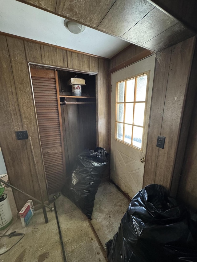 bedroom featuring wood walls and a closet