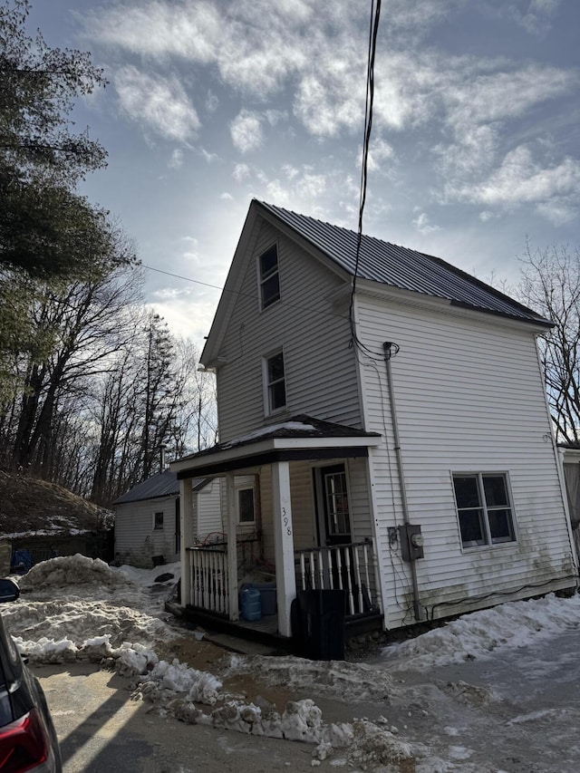 snow covered property with a porch