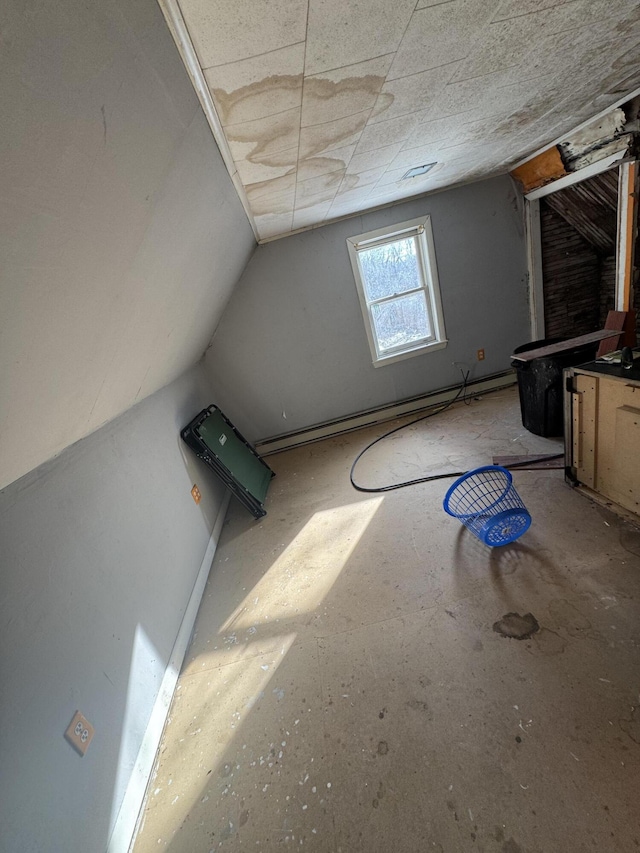 bonus room with a baseboard heating unit and lofted ceiling