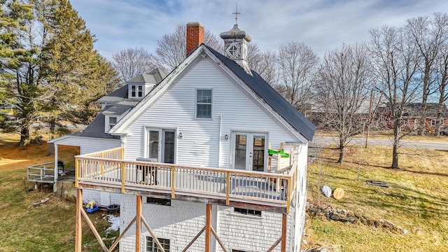 back of property featuring a yard, french doors, and a deck