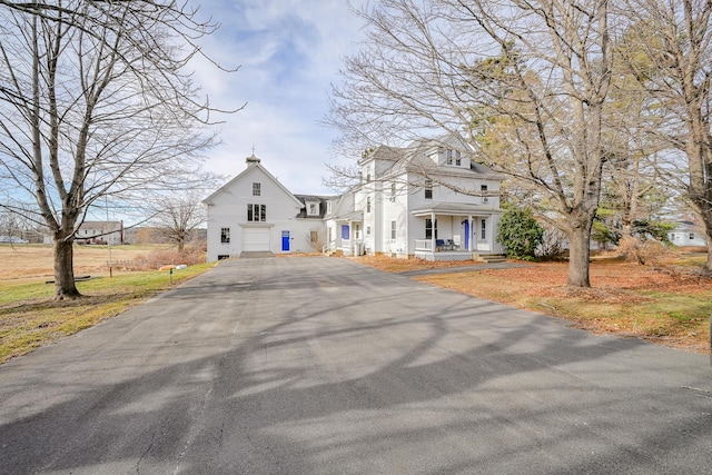 view of front of house featuring covered porch and a garage