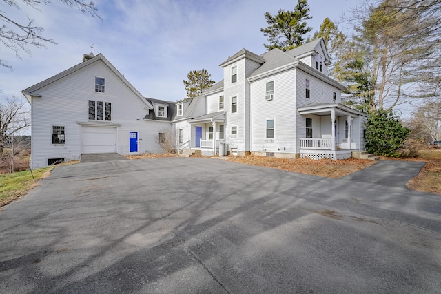 view of front of house featuring covered porch and a garage