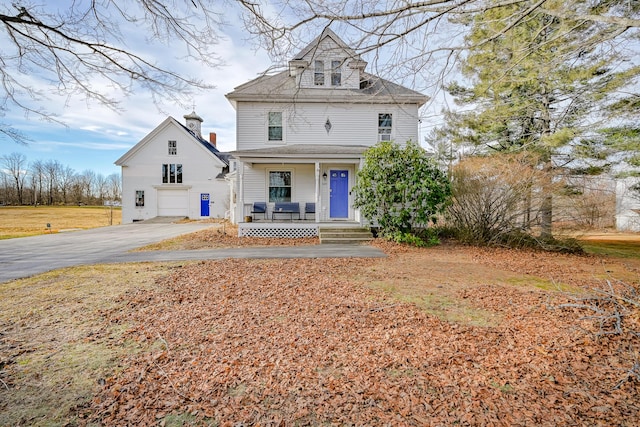 view of front of home featuring covered porch and a garage