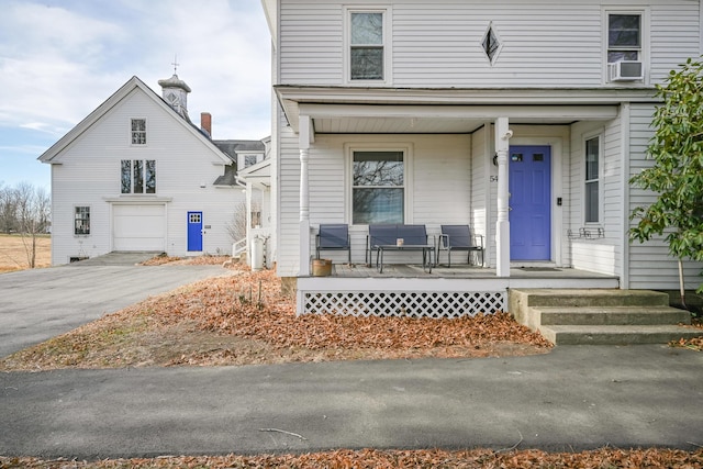 front facade with a porch and a garage