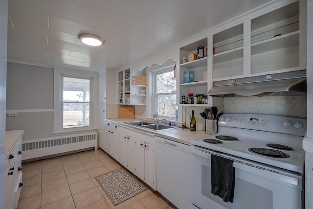 kitchen featuring radiator, white cabinetry, sink, white appliances, and light tile patterned floors