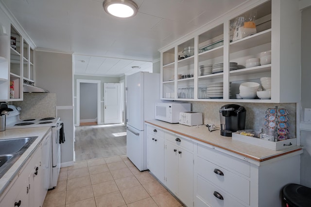 kitchen with white cabinets, white appliances, backsplash, and light tile patterned floors