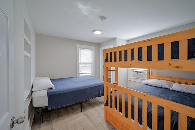 bedroom featuring light hardwood / wood-style flooring and cooling unit