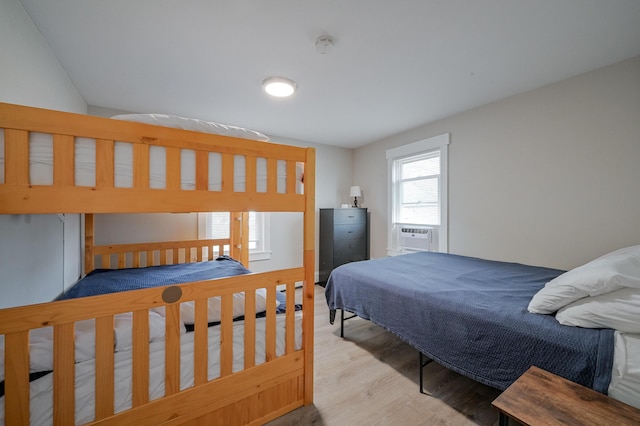 bedroom with light hardwood / wood-style flooring and cooling unit