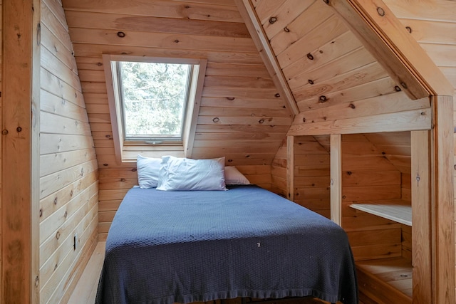 bedroom with vaulted ceiling, wooden walls, and wood ceiling