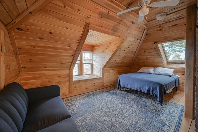 bedroom with wooden walls, ceiling fan, and wood ceiling