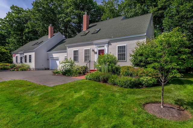 cape cod-style house featuring a garage and a front lawn