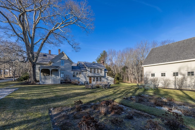 back of house featuring a yard